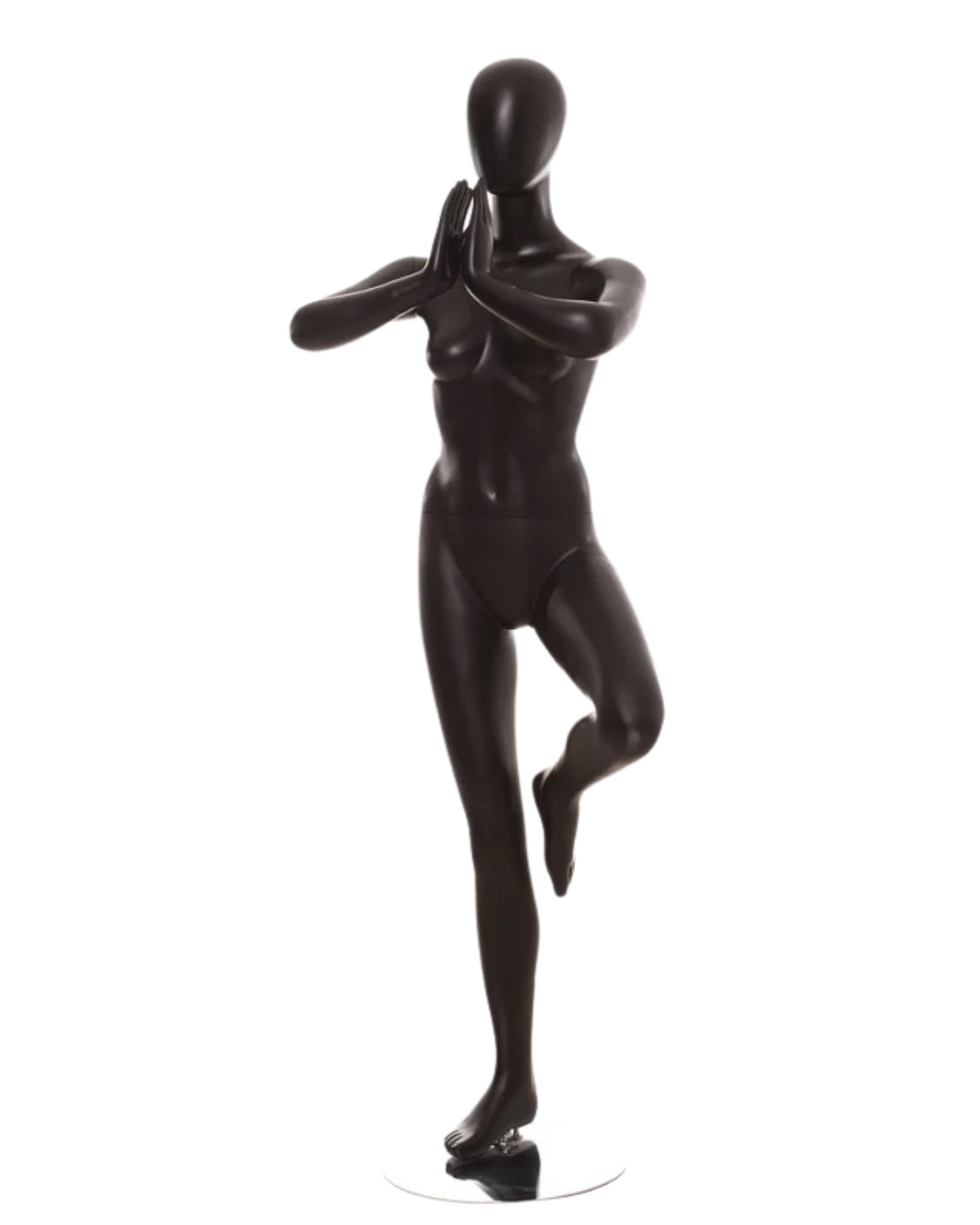 A glossy black mannequin figure posed in a yoga tree pose on a small round base, photographed against a plain white background.