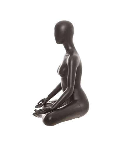 A glossy black female mannequin figurine posed in a seated meditation or yoga pose, shown from the side against a plain white background.
