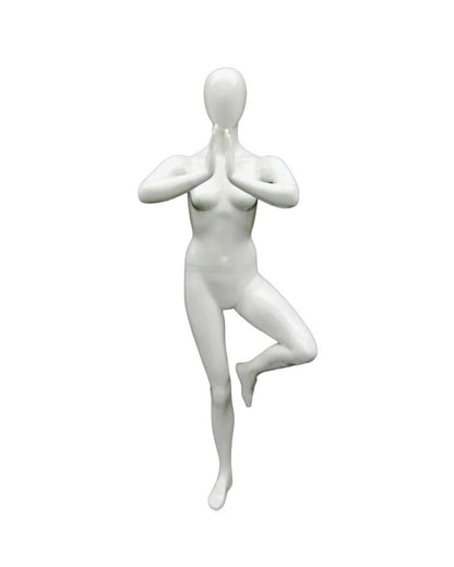 Posable female mannequin in white performing Tree Pose, used for yoga display by Roxy Display.